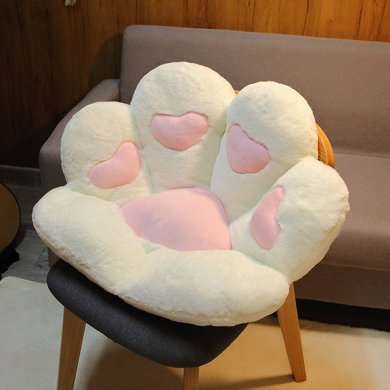 White cat paw cute cozy cushion on chair