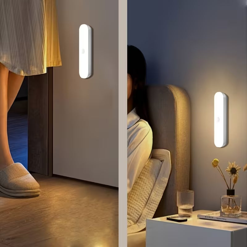 wo scenes showing a slim white motion sensor night light mounted on walls, illuminating a bedroom and hallway; one lighting a woman walking near a door and the other glowing beside a bedside table with a glass of water and diffuser.