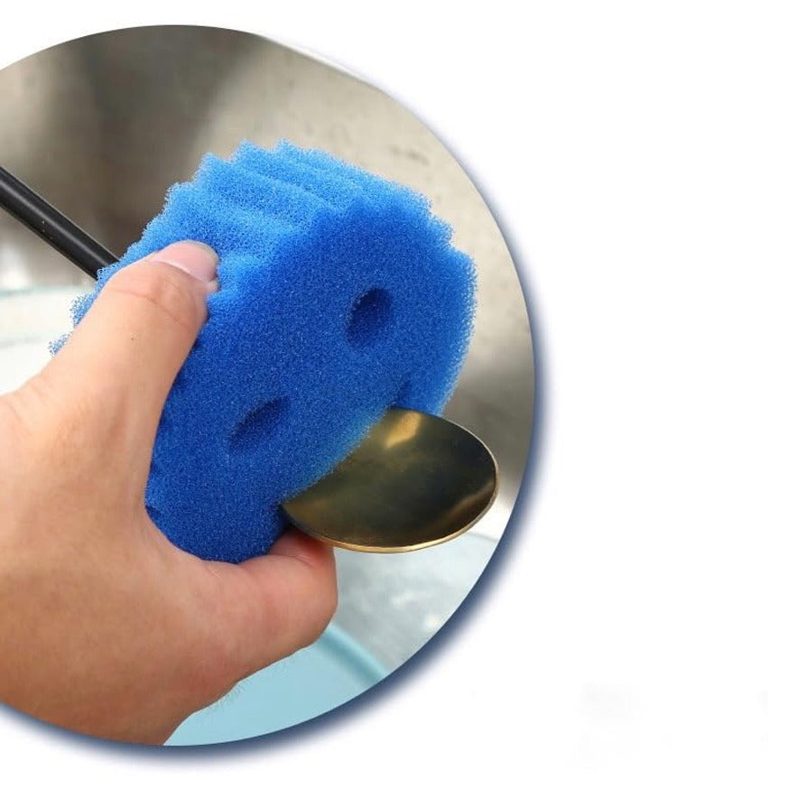 A Spoon is Cleaned Using Smiley Face Kitchen Scrubber.