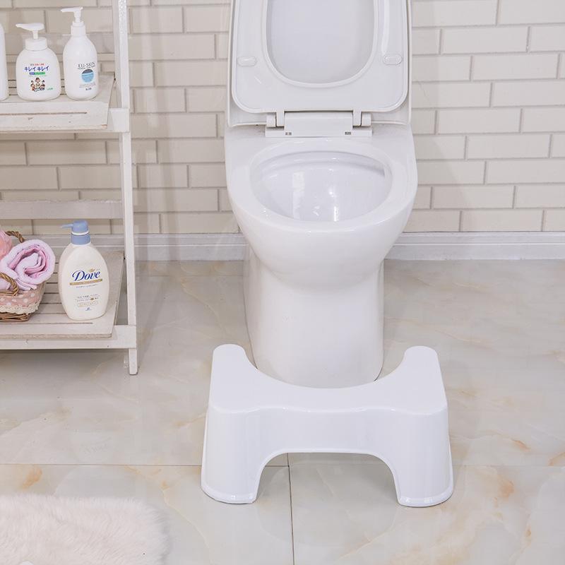 A toilet with a squat stool