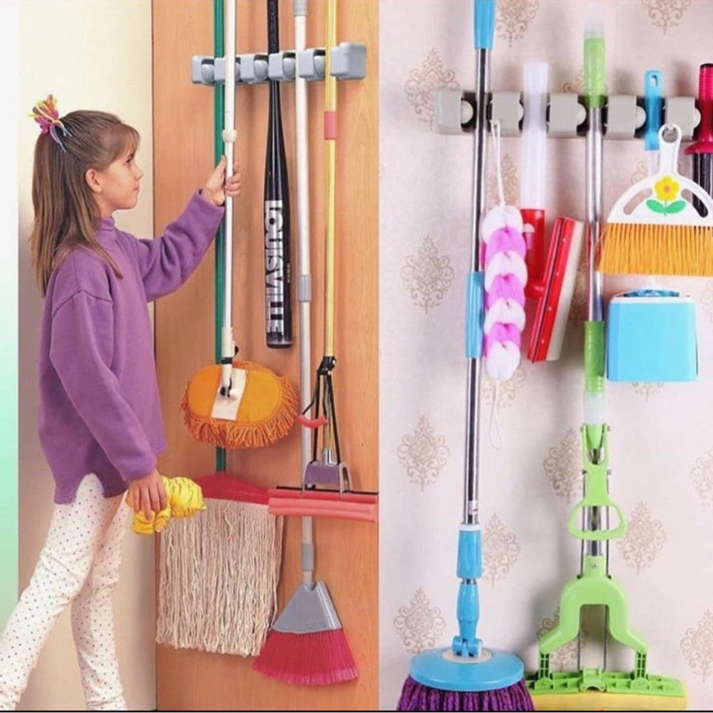 A child taking a mop from mop holder