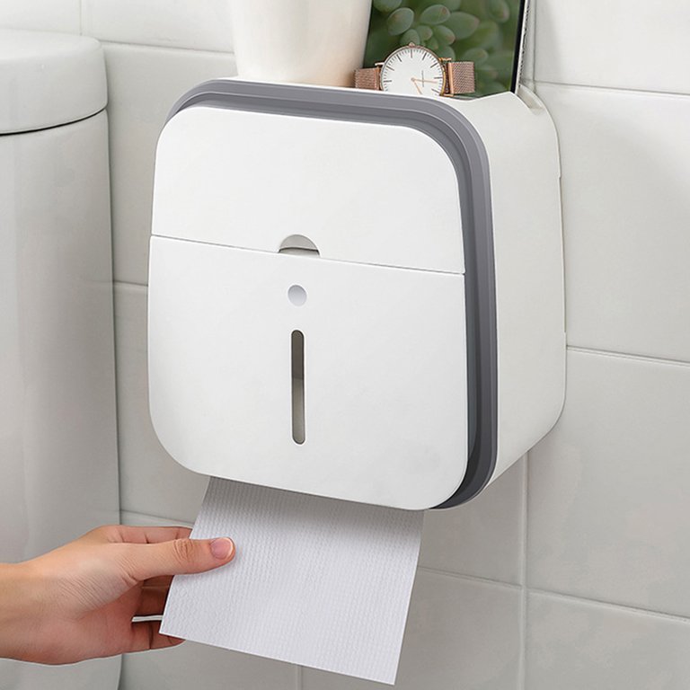  A hand grabs a paper towel near the toilet - a toilet paper holder within easy reach
