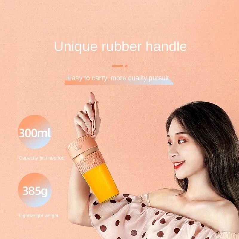A girl holding a 300ml USB Portable Electric Juicer Blender
