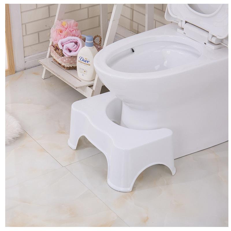 A toilet with a squat stool