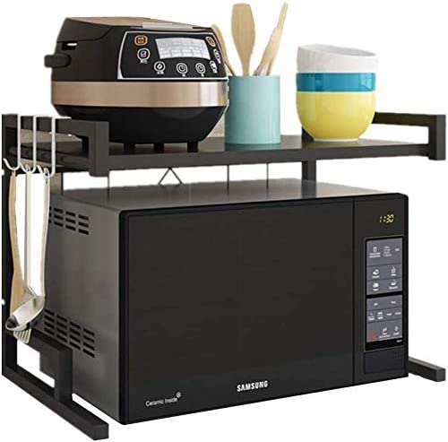 A microwave oven with an adjustable carbon steel rack and various utensils neatly arranged inside