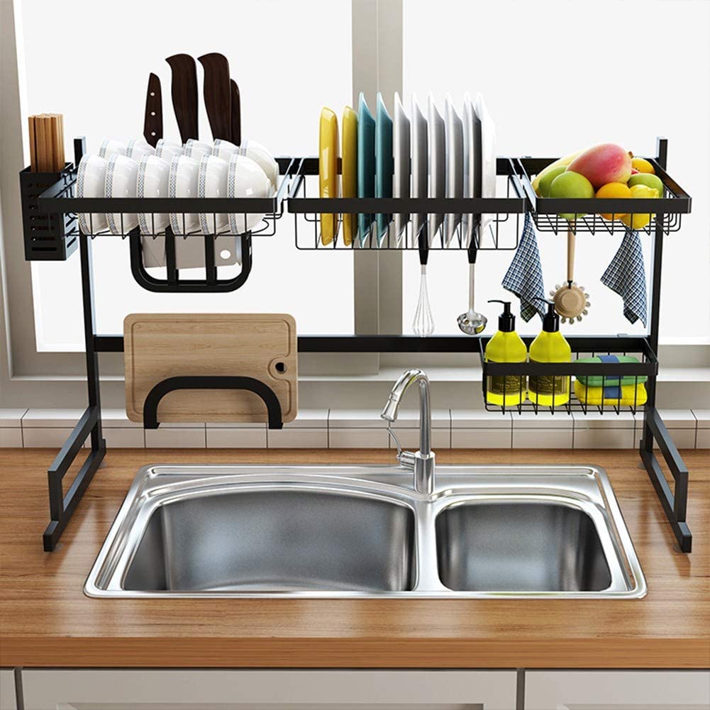 A sink with a dish rack and utensils