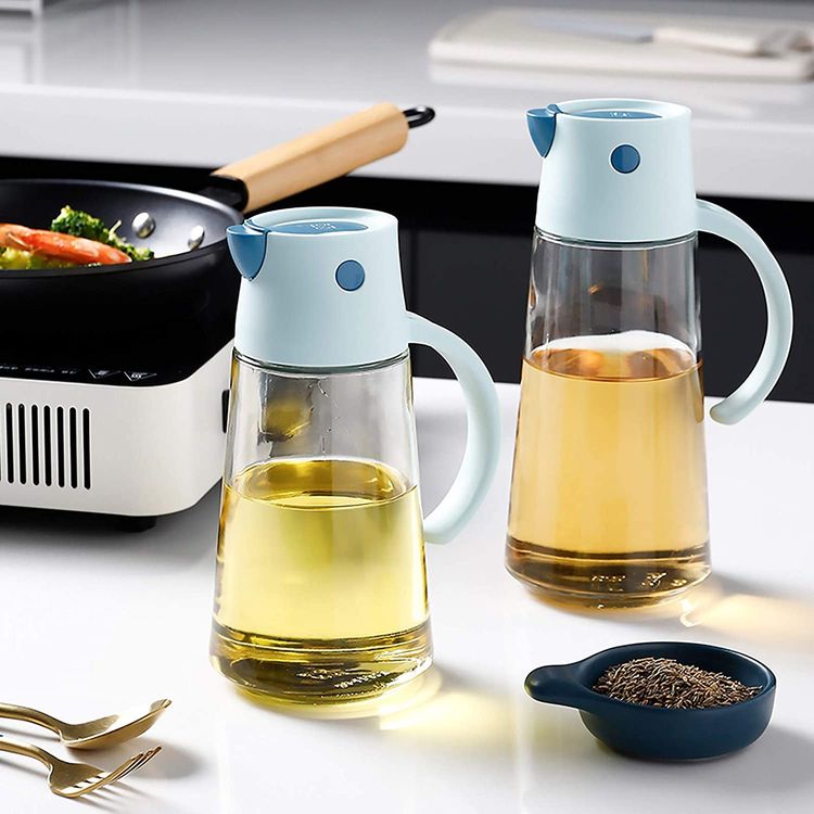 The 650ml Capacity Kitchen Automatic Oil Dispenser Bottle is placed in the kitchen