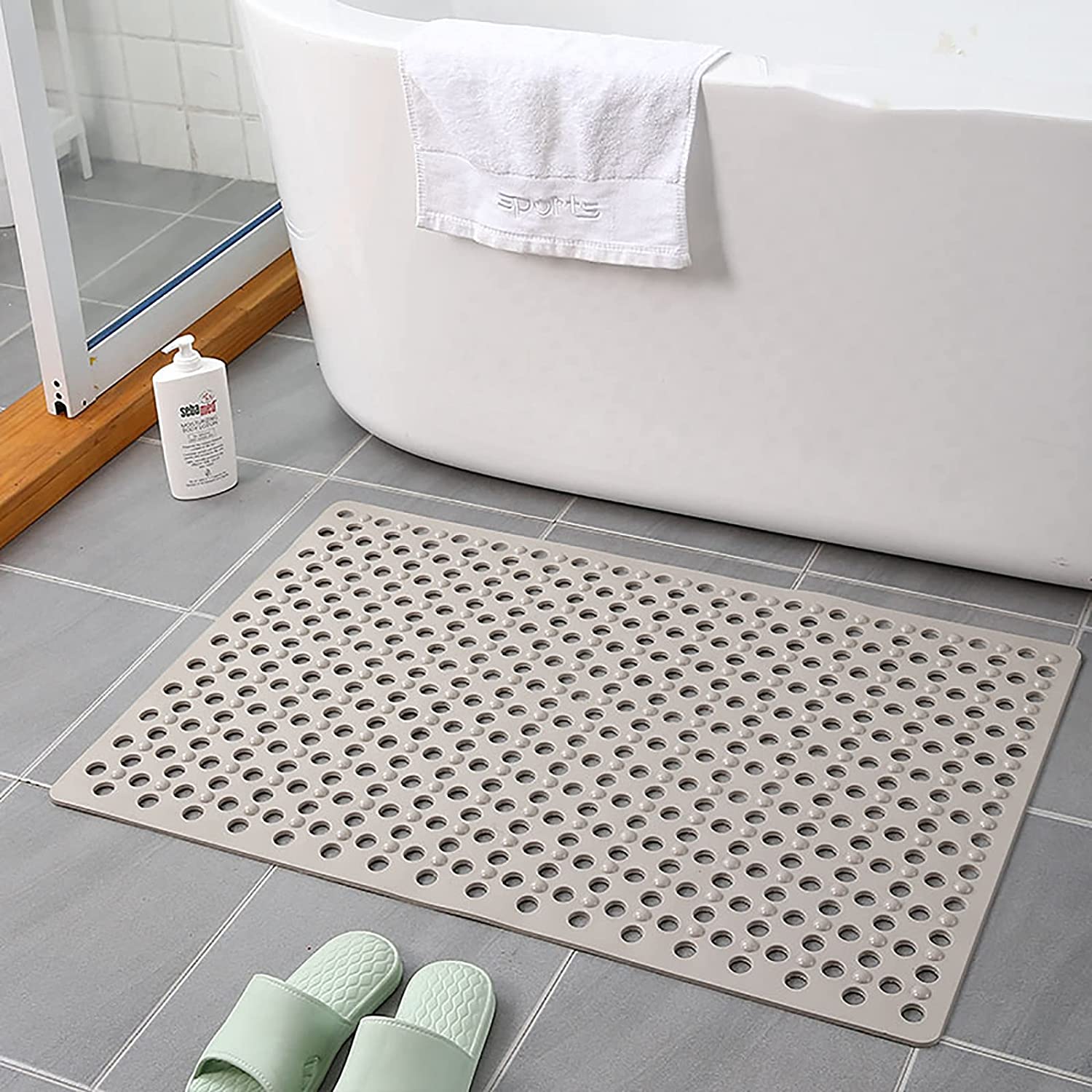 Non-slip extra-long bathroom shower mat placed in the bathroom in gray color