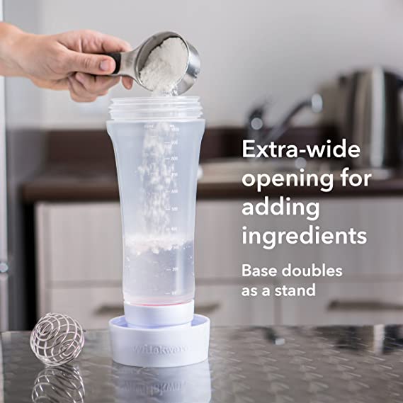 A person pouring powder into a Whiskware Pancake Batter Mixer