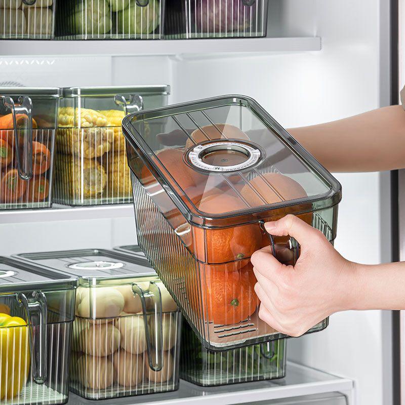  A person holding a Fridge Organizer Storage Box