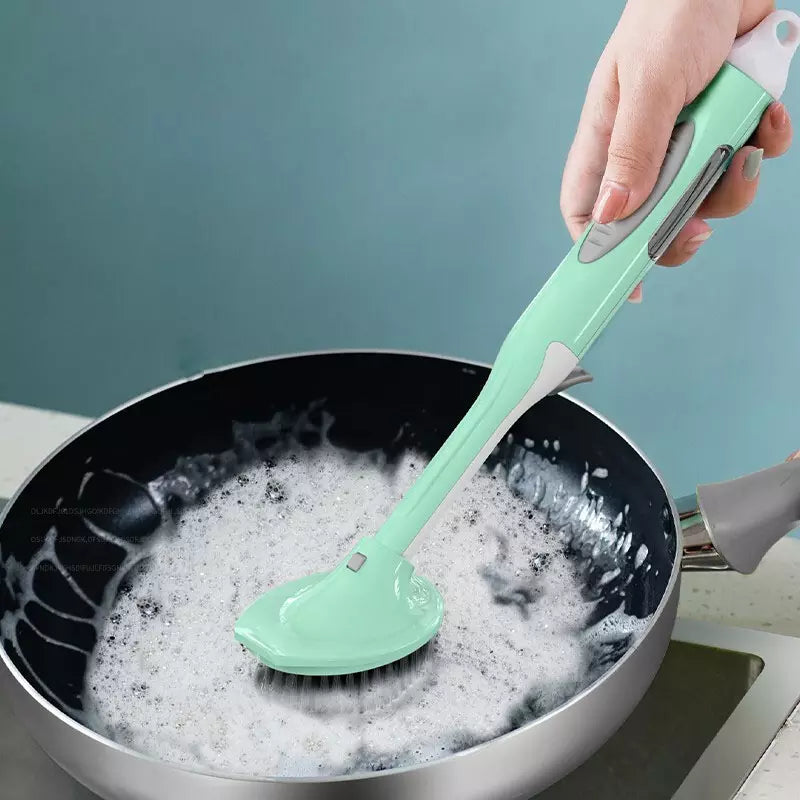 Someone using a Long Handle Kitchen Dish Brush with a soap dispenser