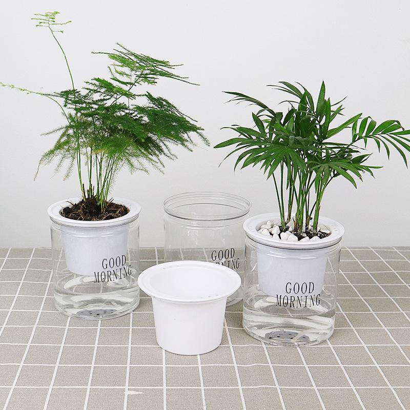 Three Self Watering Indoor Plant Pots, one with lid opened and the other both with plants placed on floor 