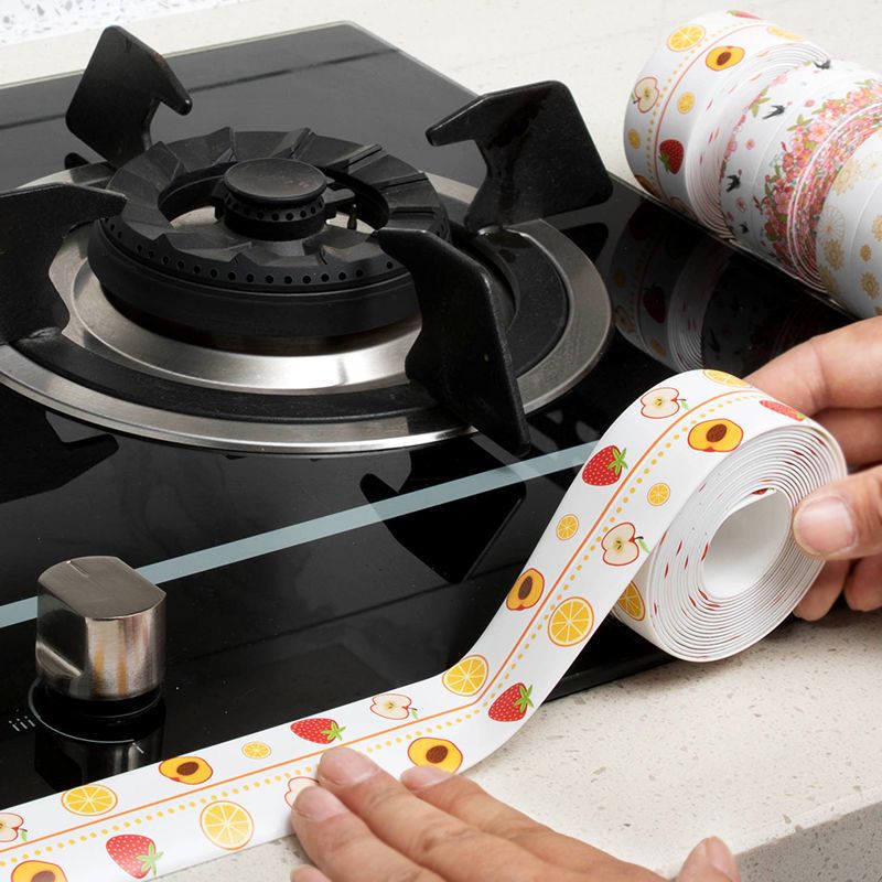 Someone is using adhesive tape for the kitchen sink on the stove