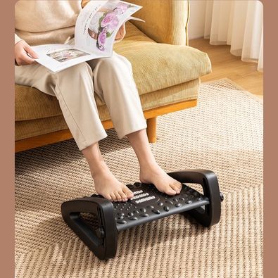 A person using an adjustable footrest designed for home office use