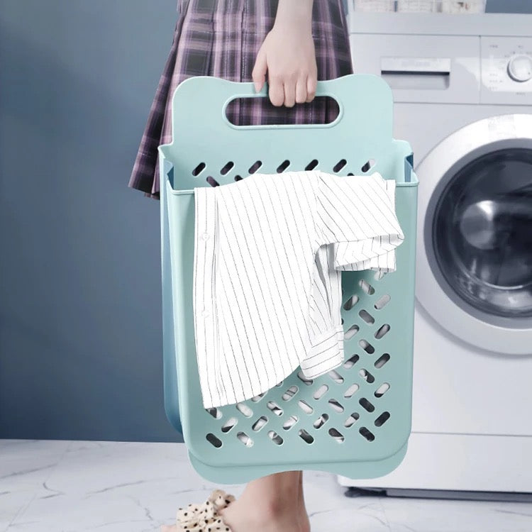 A lady holding a Collapsible Wall Mount Laundry Basket