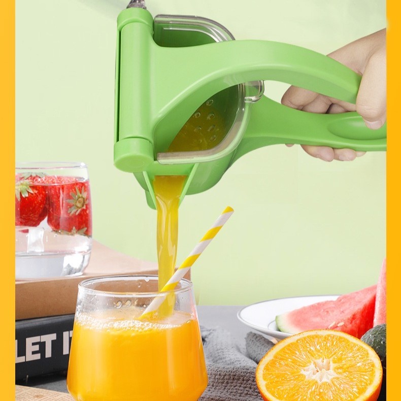 Someone making with the help of a manual juicer, handheld, non-electric lemon squeezer