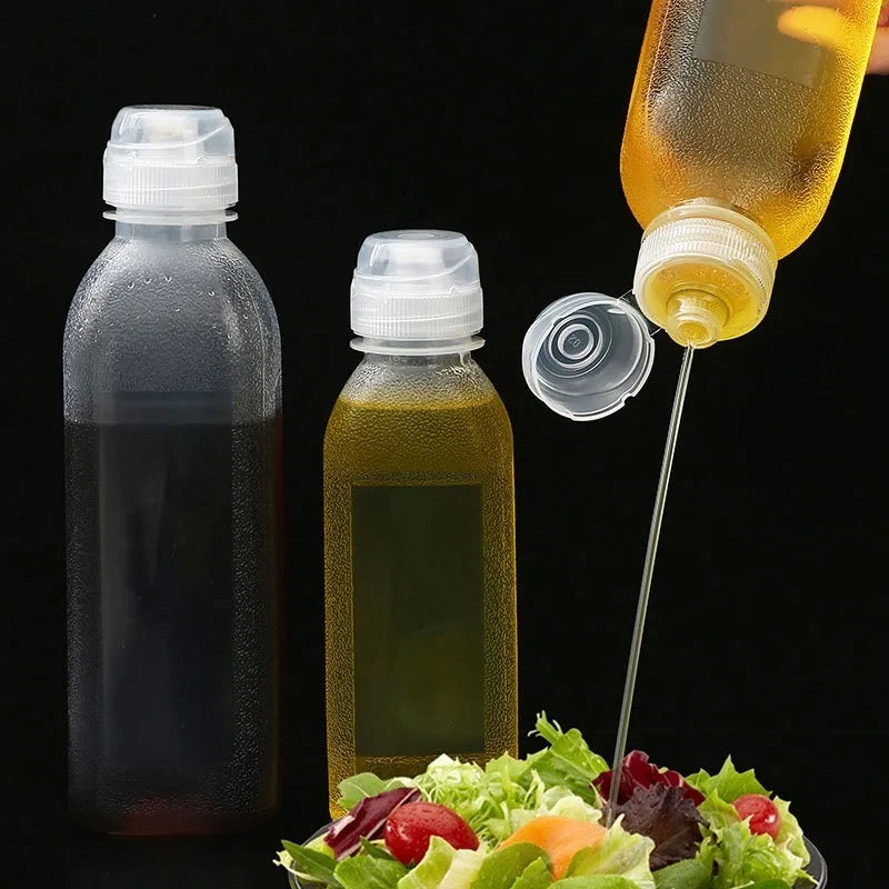 Someone is pouring oil onto vegetables using a Kitchen Oil Spray Injection Press Bottle Sprayer Dispenser