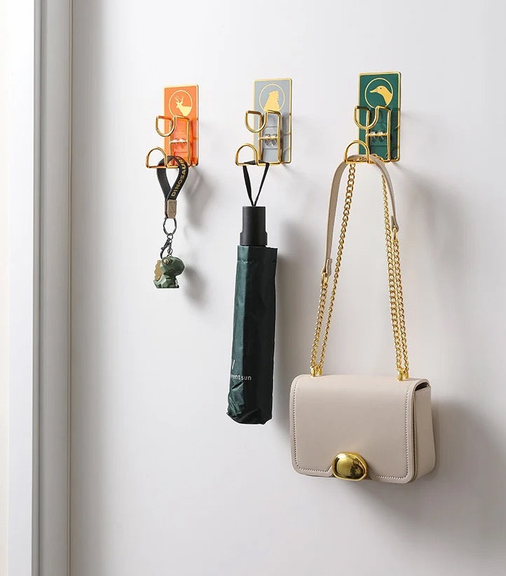 A wall mounted hook displaying a purse and handbag, perfect for keeping your accessories organized and easily accessible