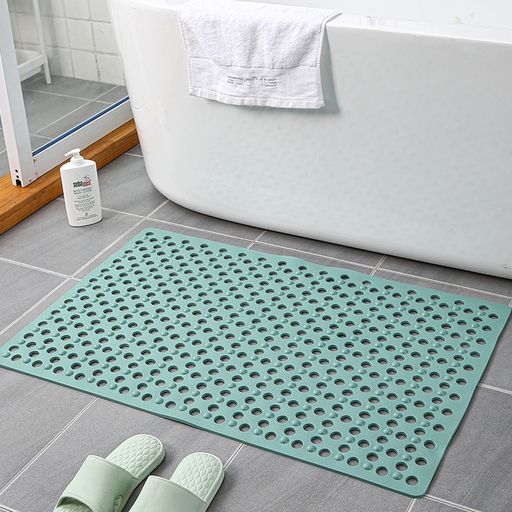 Non-slip extra-long bathroom shower mat placed in the bathroom in green color
