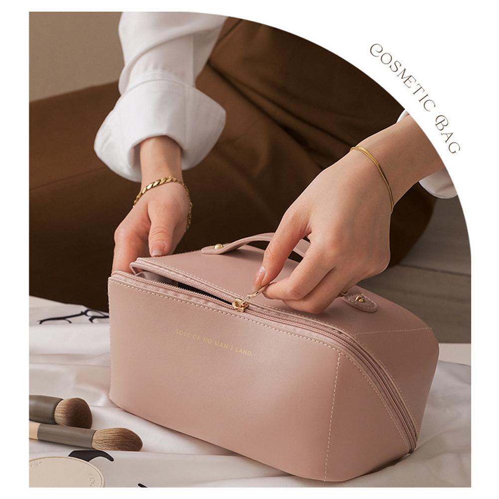 A lady is opening the Large Capacity Foldable Travel Cosmetic Bag