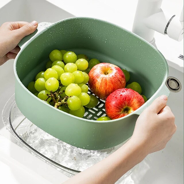 Someone is holding the Double Layer Vegetable Fruit Washing Drain Basket Storage