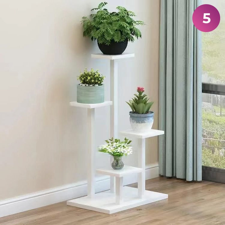 4-Layer Indoor Plant Stand with some plants placed next to a window in a room