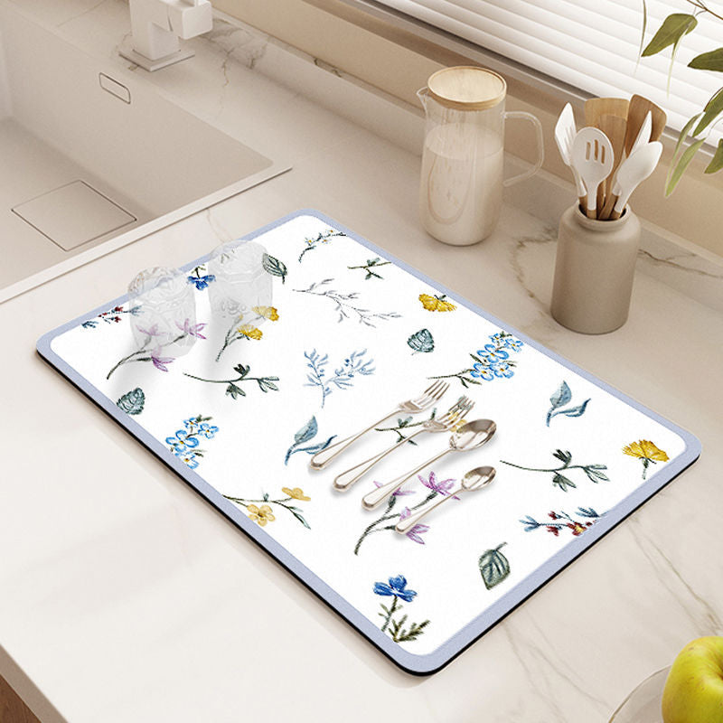 Showcasing Dish Drying Mat with spoons,forks and two glass cups kept on a kitchen counter top near to a sink
