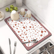 Showcasing Dish Drying Mat with spoon and mugs kept on a kitchen counter top 