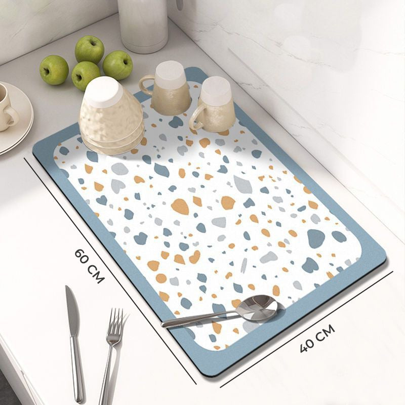 Showcasing and displaying the size of Dish Drying Mat with spoon and mugs kept on a kitchen counter top 