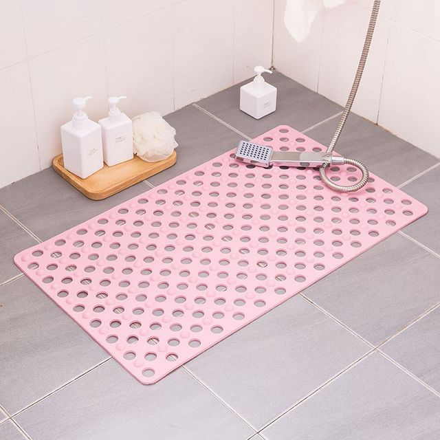 Non-slip extra-long bathroom shower mat placed in the bathroom in pink color