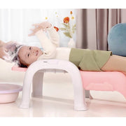 baby shampooing in baby chair 