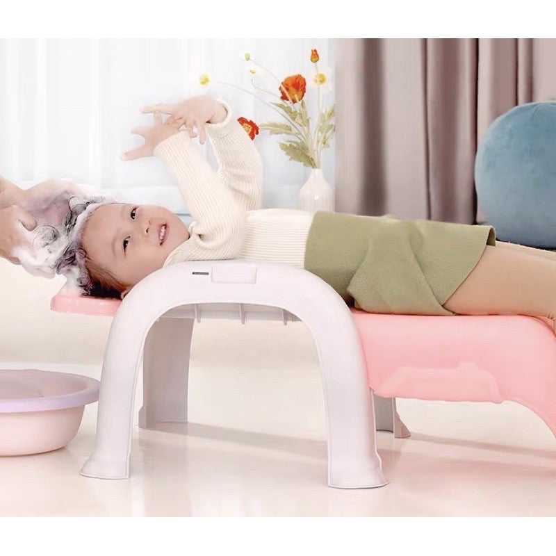 baby shampooing in baby chair 