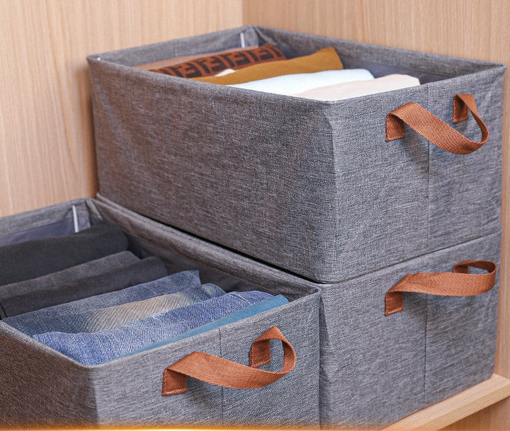 Three gray cloth wardrobe storage bins featuring convenient handles for easy transportation