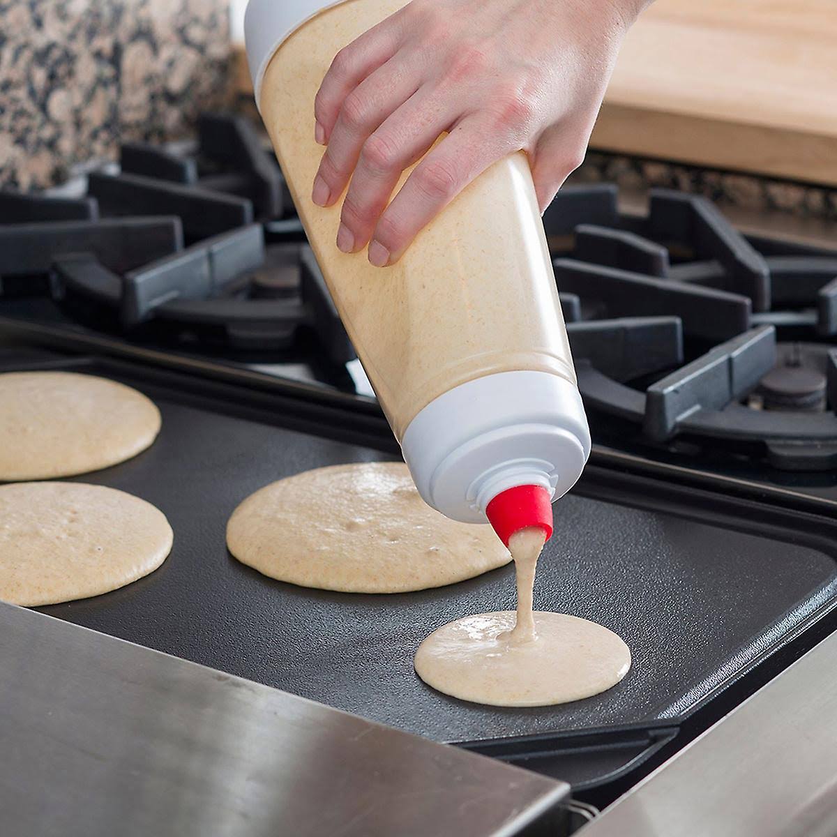 Someone making food with the help of the Whiskware Pancake Batter Mixer