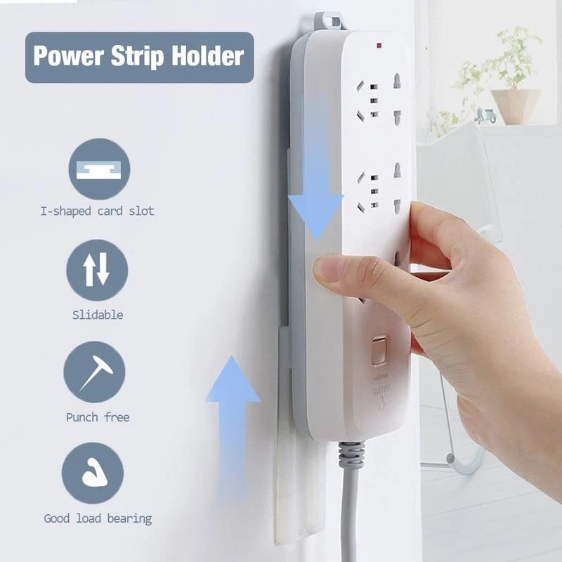 A hand trying to hang socket on Wall Mount Punch Free Socket Holder