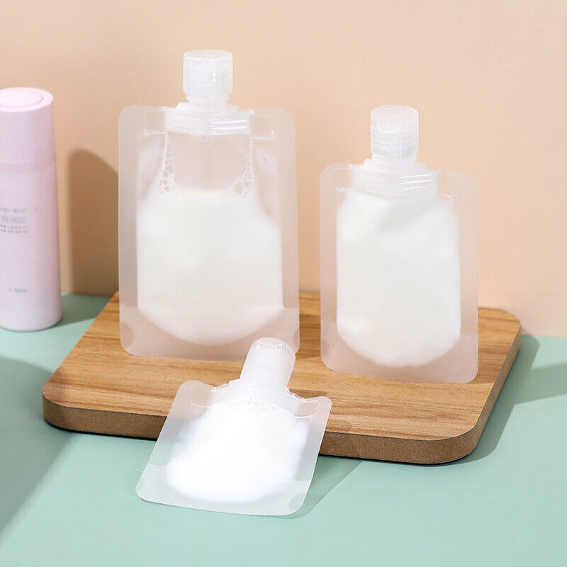 A group of Shampoo Lotion and Dispenser Bags on a wooden board