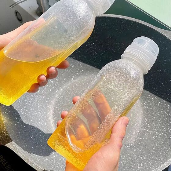 Someone is holding a Kitchen Oil Spray Injection Press Bottle Sprayer Dispenser