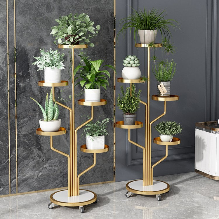 Two Golden color Indoor Plant Stands placed in a room along with plants 