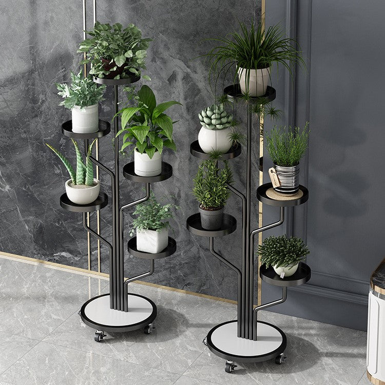 Two Black color Indoor Plant Stands placed in a room along with plants 